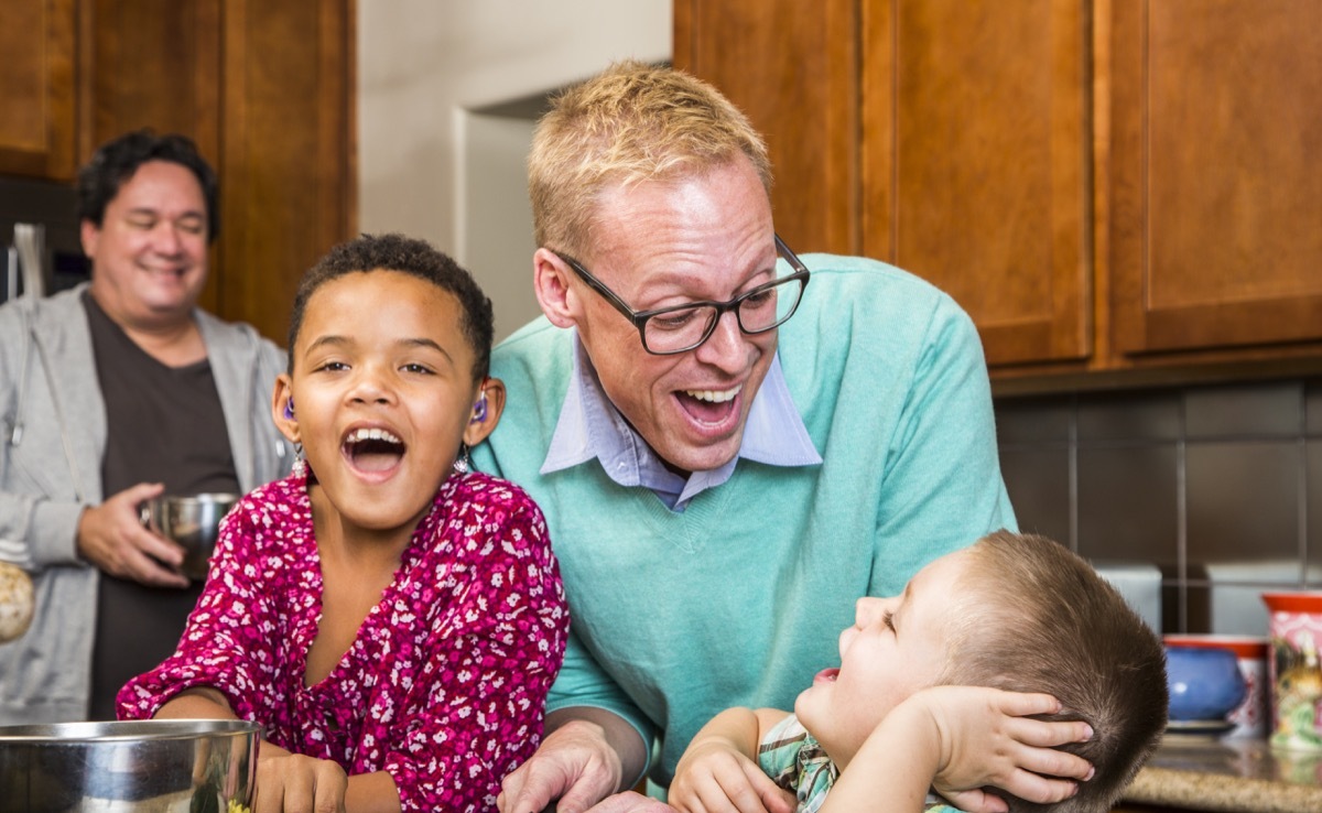 dads laughing in kitchen with kids