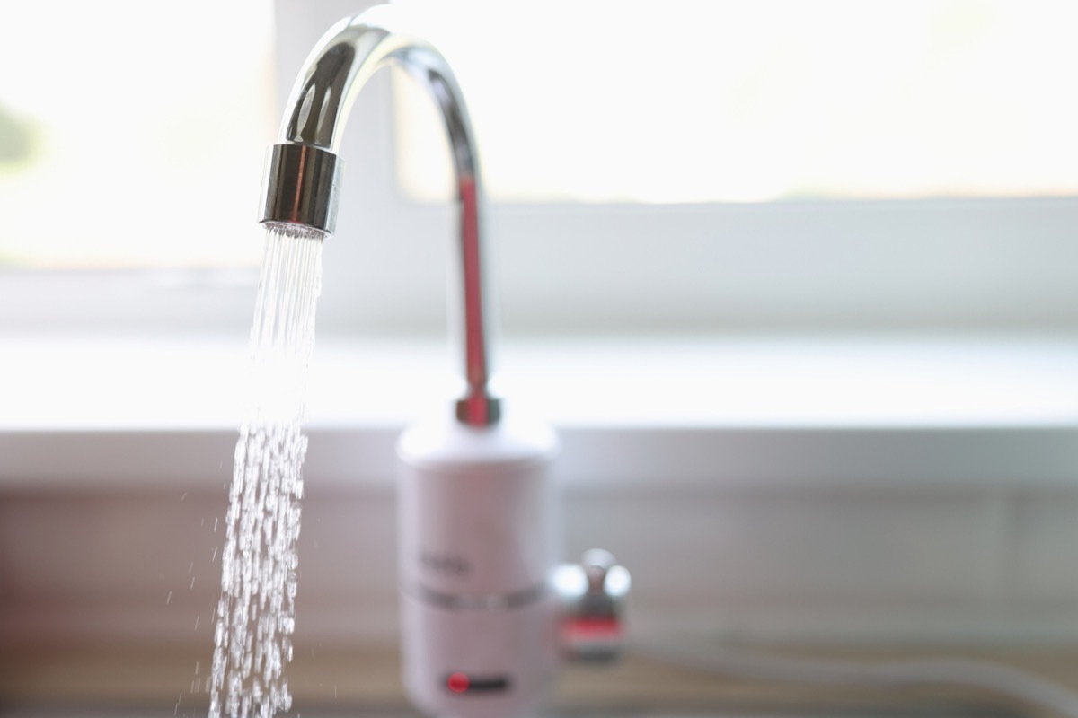 Pure water flows from faucet in kitchen