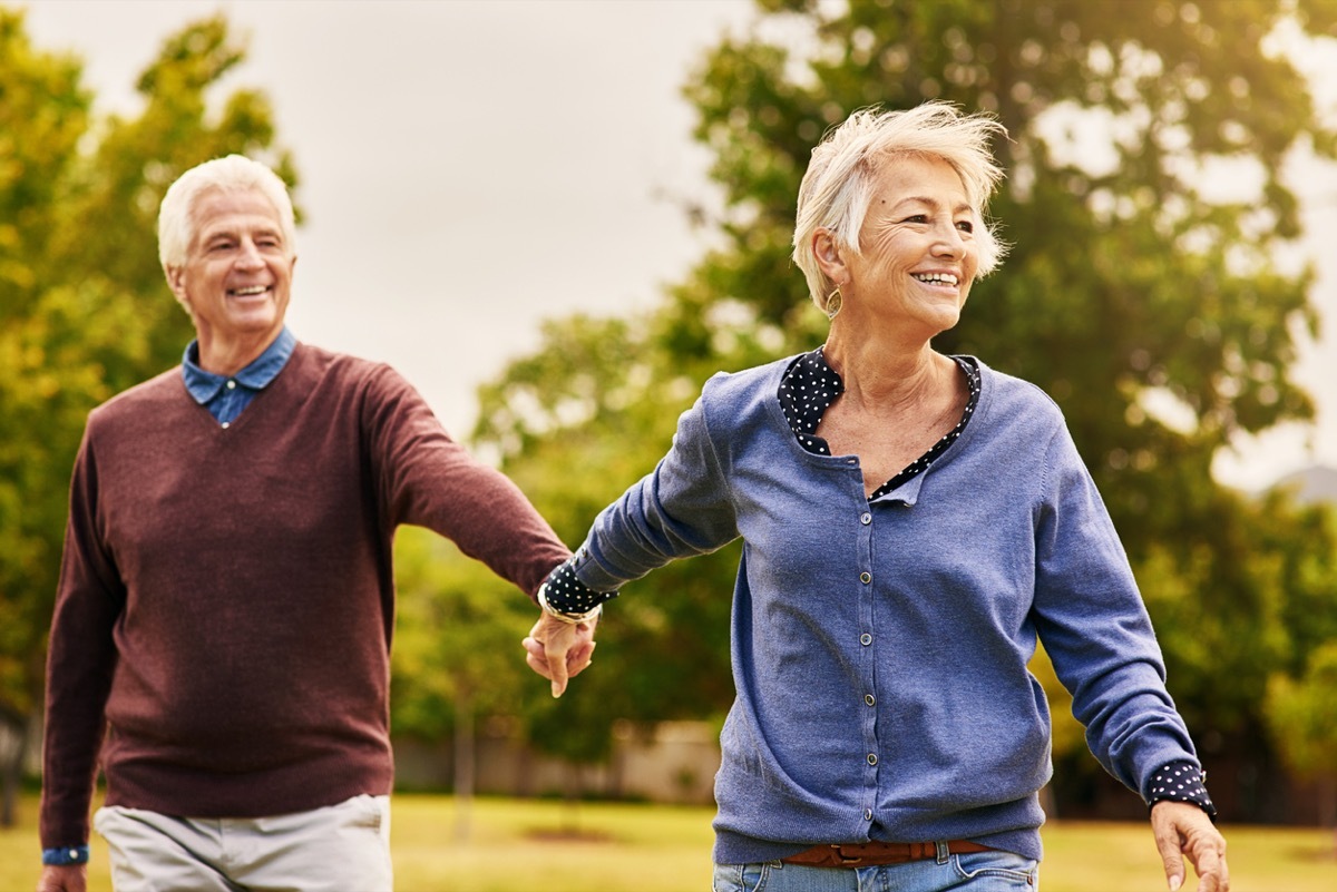 older white man and woman walking outside