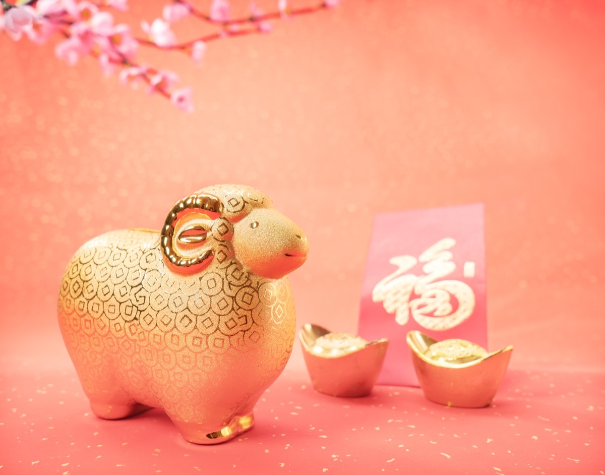 gold goat against a pink background representing the chinese zodiac