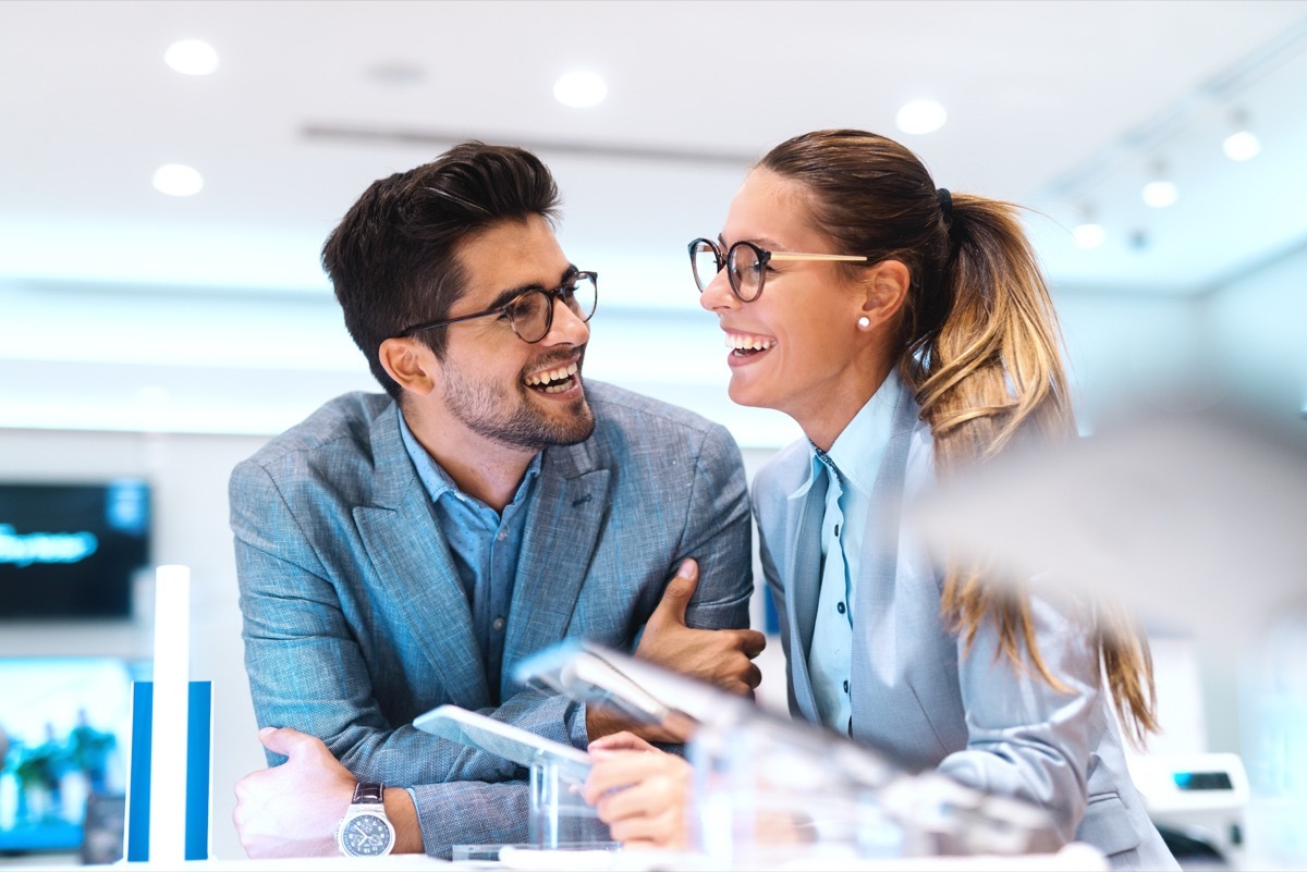 Confident man and woman laughing