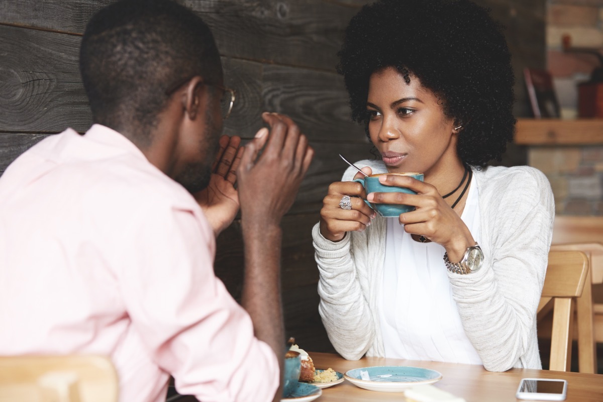 couple chatting while drinking coffee at a cafe