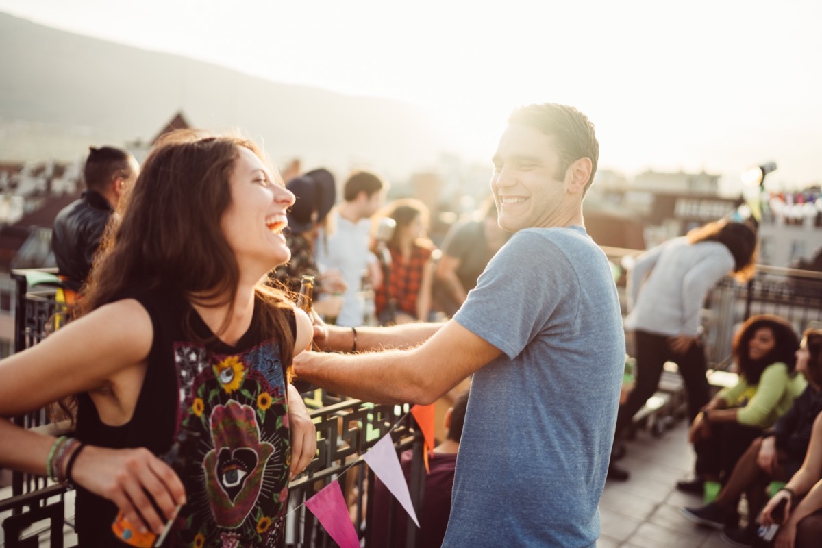 man flirting with woman at outside bar