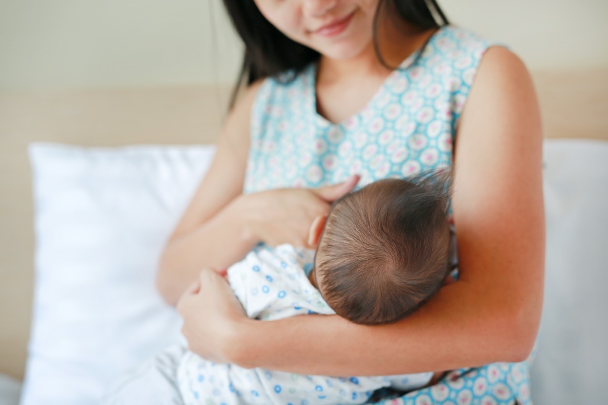 young asian mom nursing baby