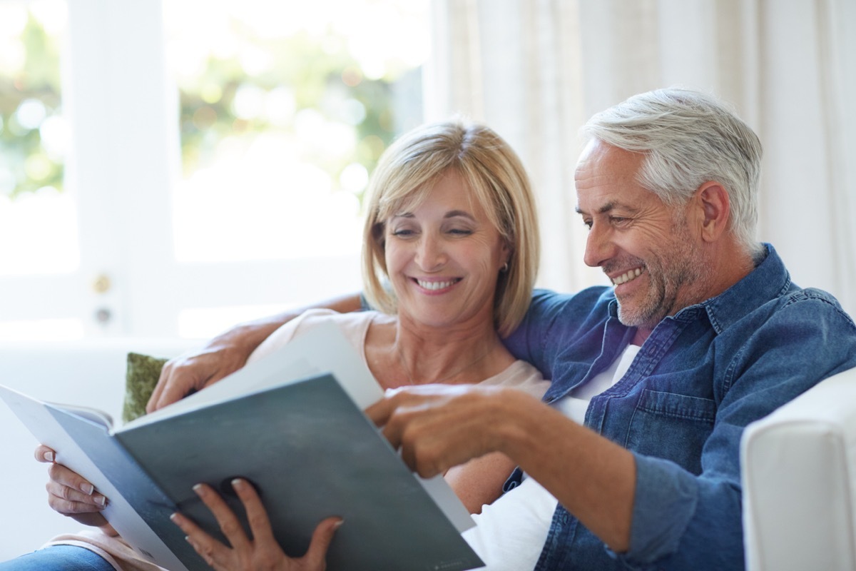 Cropped shot of a mature couple looking at an old yearbook