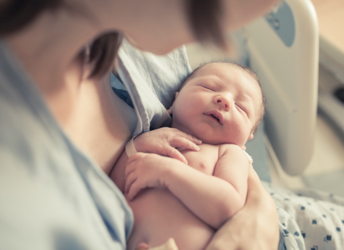 mom holding newborn baby at the hospital