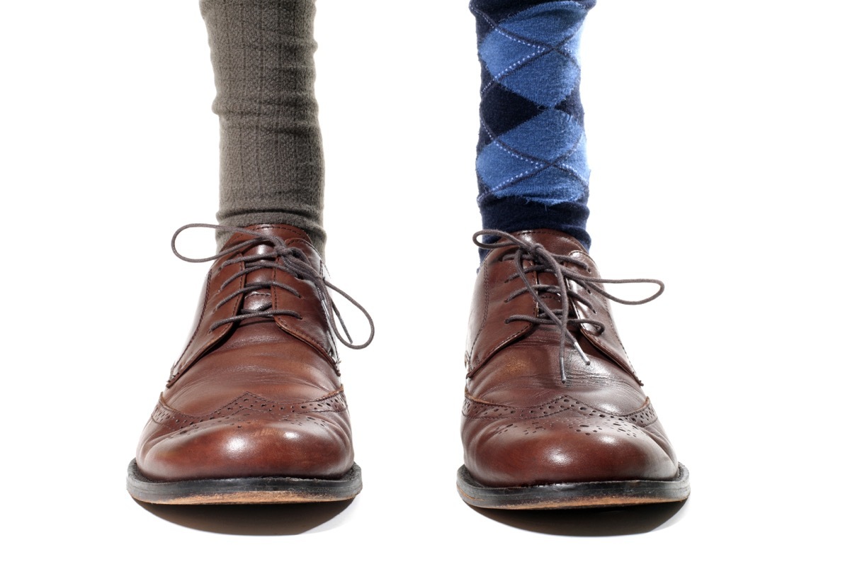 Man wearing mismatched socks with business shoes