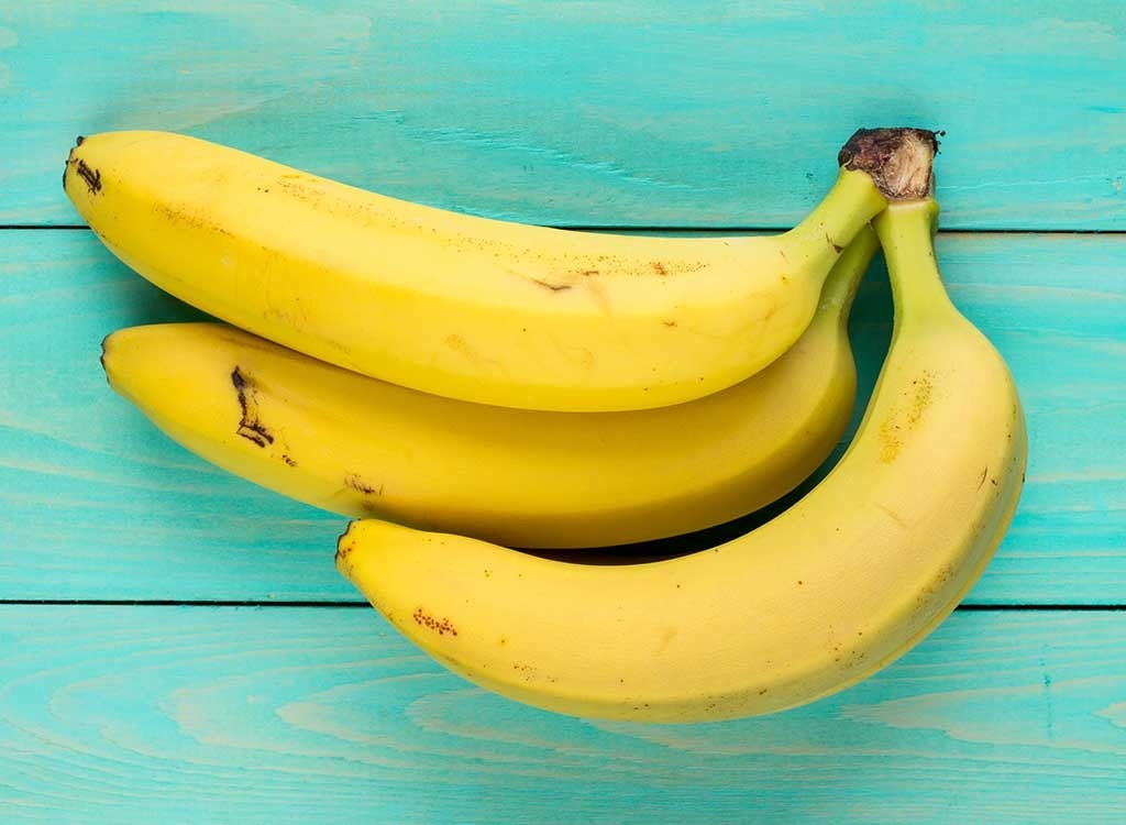 Banana bunch on blue background high fiber foods