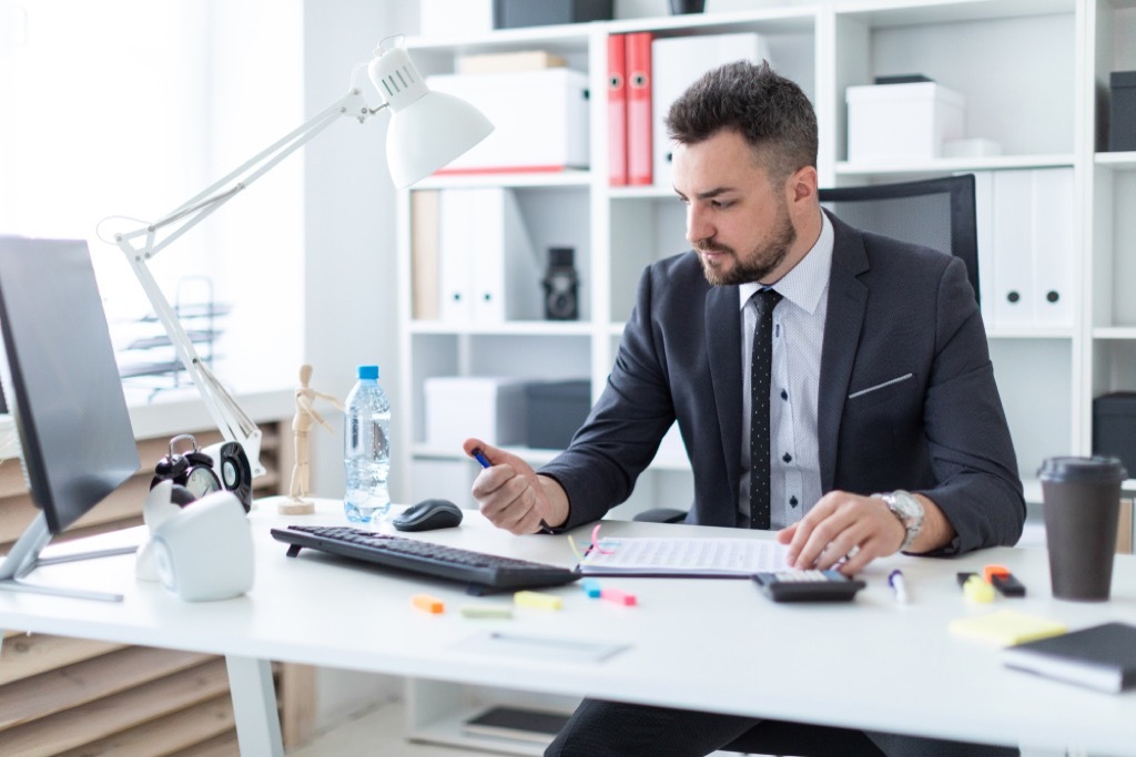 man clicking pen