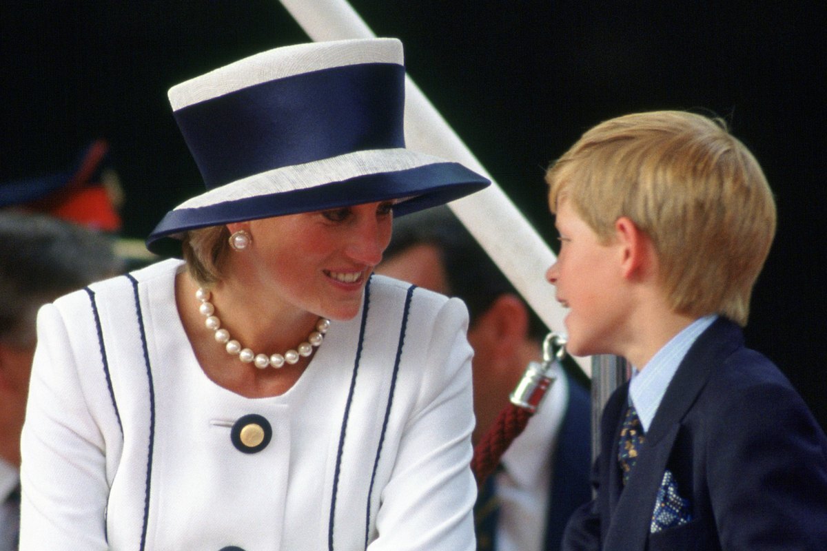 Prince Harry talks to his mother, Diana, Princess of Wales who wears a suit designed by Tomasz Starzewski to VJ Day commemorations 