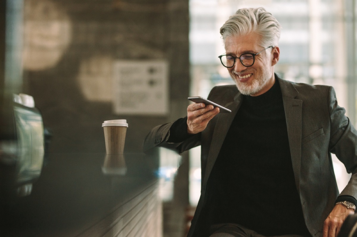 older man talking on speakerphone at a cafe, annoying things people do